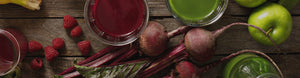 juice, beets, and apples on a wood table