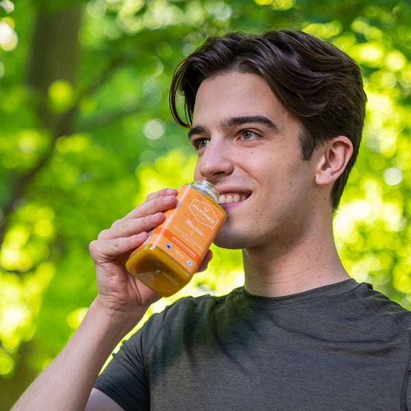 monsoon smoothie pulp and press person drinking outside smiling