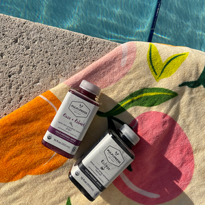 pulp & press juices rinse & rebeet and eclipse on beach towel with pool in background